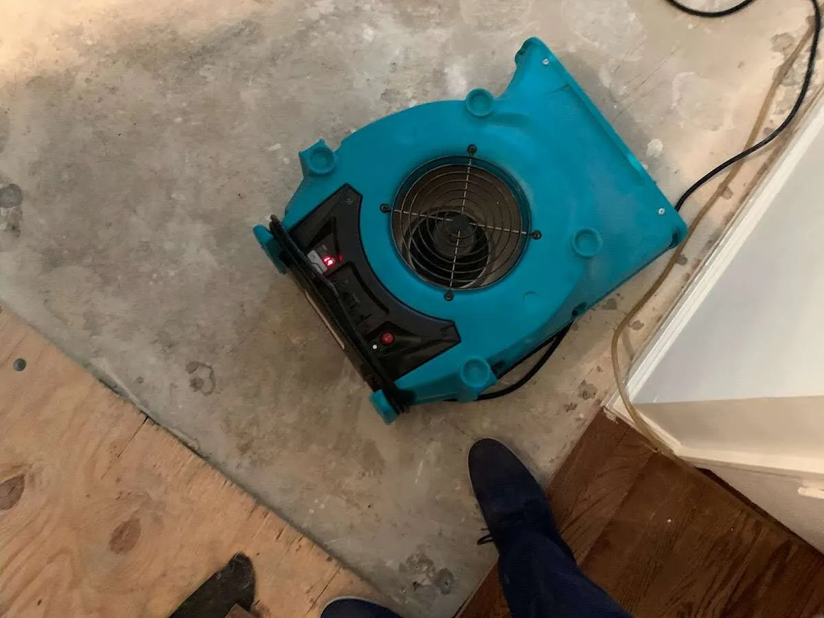 Air mover drying subfloor during Commercial Water Damage Restoration in Pennsville
